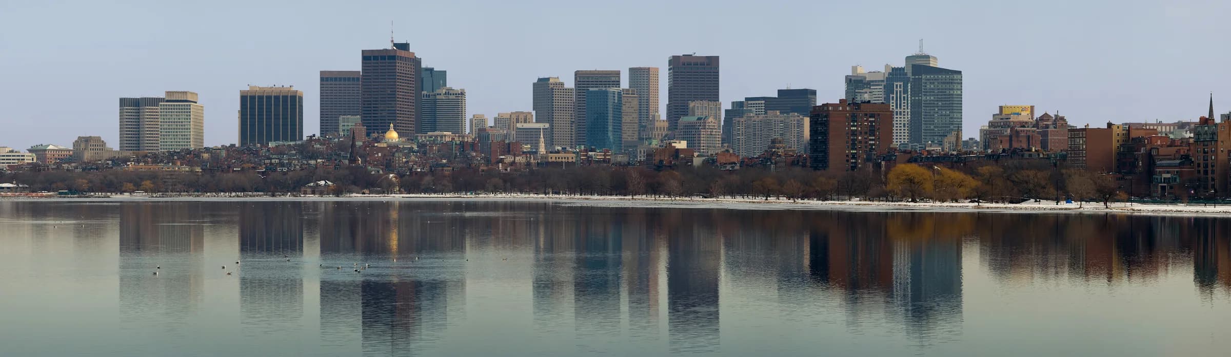The Charles River basin — Cambridge on one bank, Back Bay on the other, and the Red Line crossing between.